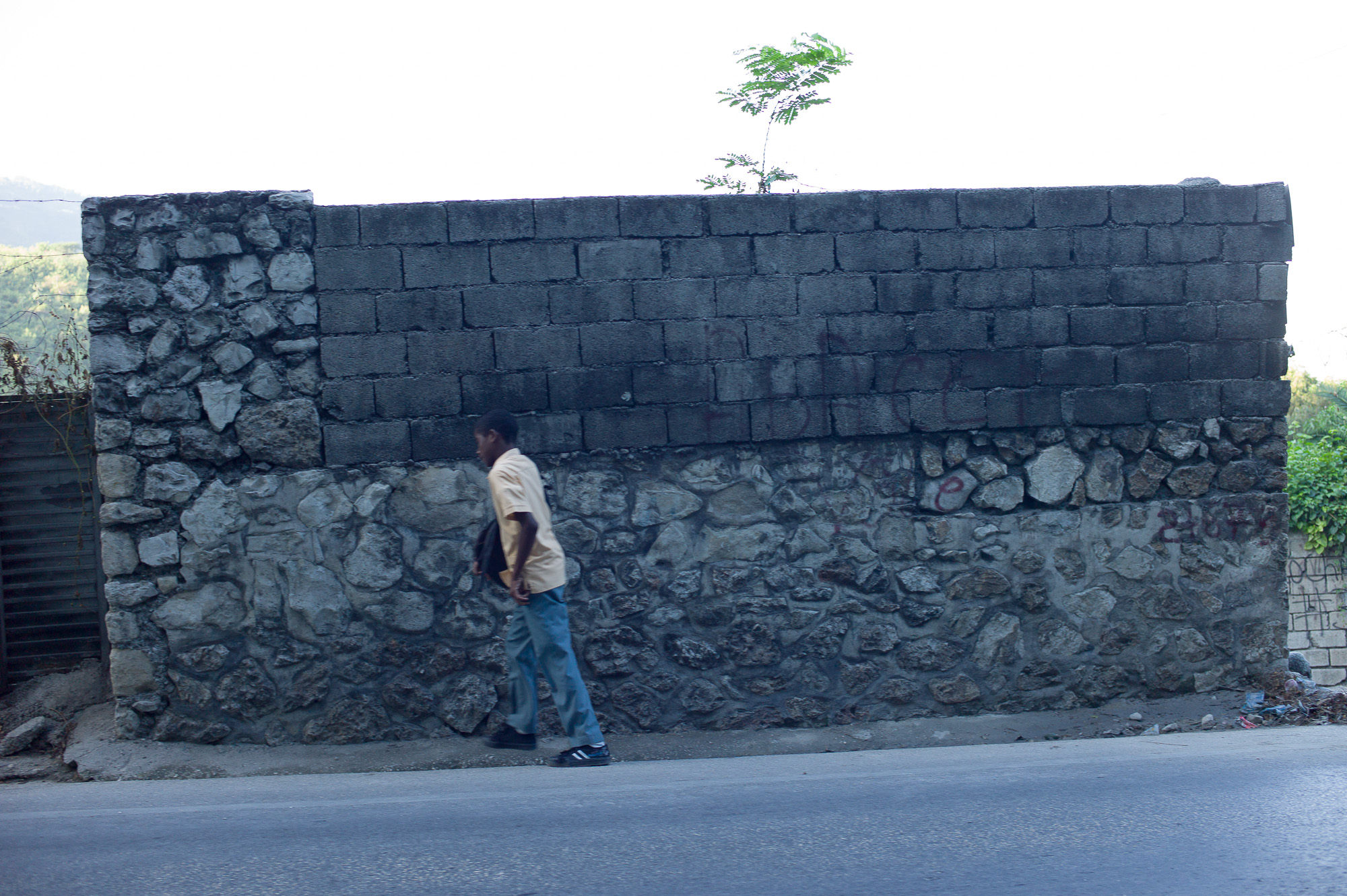 White Shirt and stone wall. Avenue Lamartiniere, Port Au Prince, Haiti. 2011<br/>